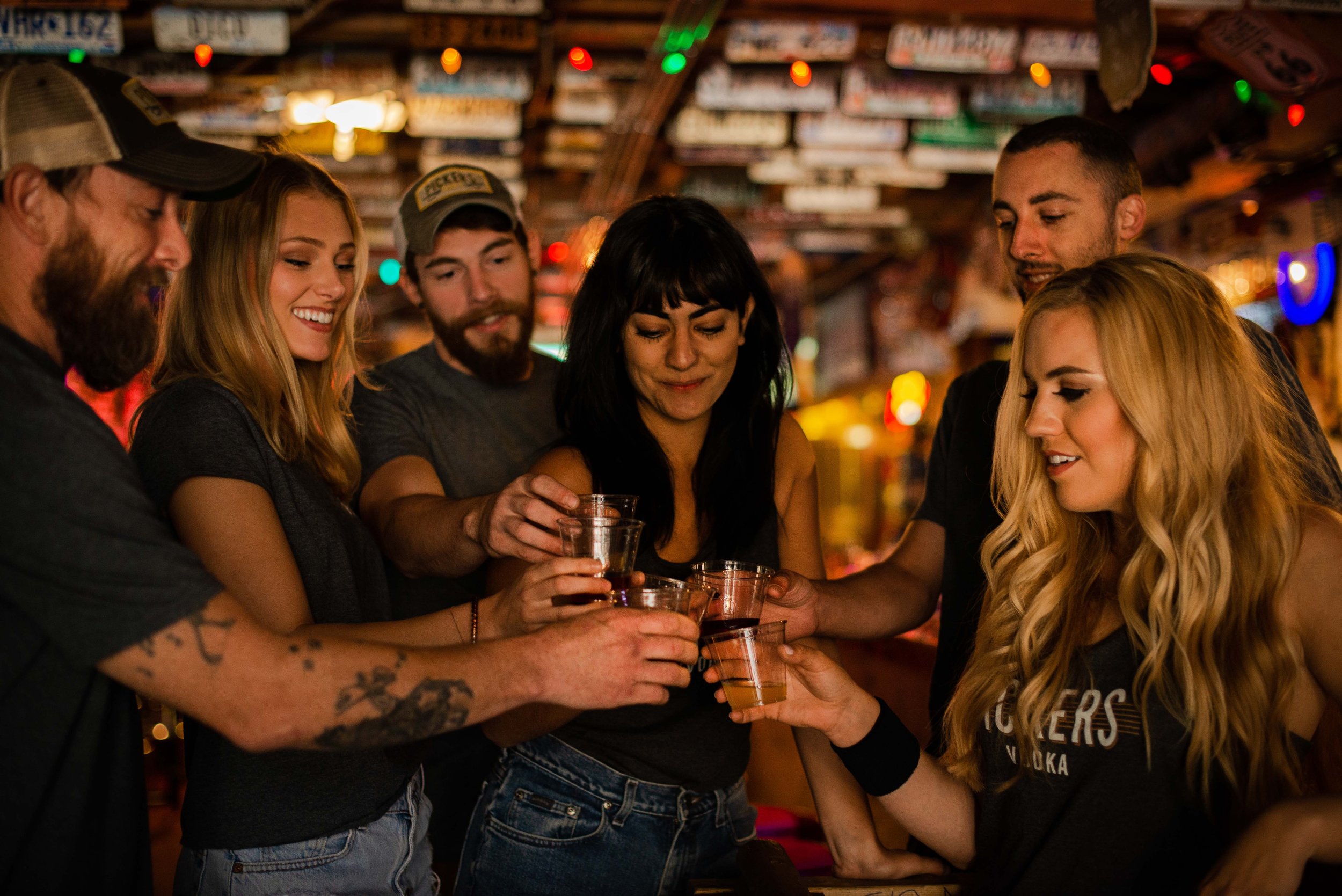 group of friends in nashville at a bar drinking pennington distilling co. products and having a great time